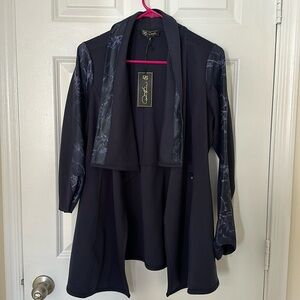 Glamourize your wardrobe with this comfy shawl collar jacket by Diane Gilman.